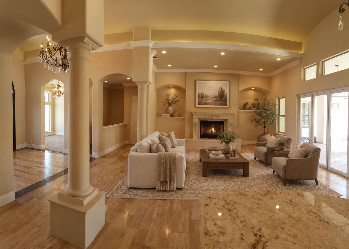 Great room with a fireplace, recessed niches and broad windows